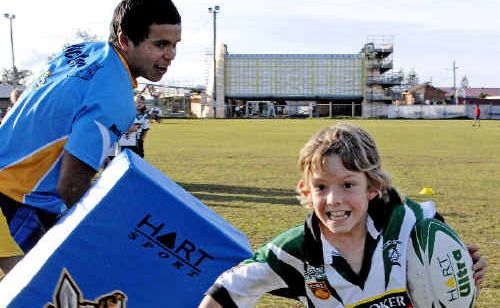 Jordan Chapman (right), 9, of Lennox Head gives the Titans a run for their money at the Lennox Head tornado appeal fundraiser yesterday. Jordan Chapman (right), 9, of Lennox Head gives the Titans a run for their money at the Lennox Head tornado appeal fundraiser yesterday.